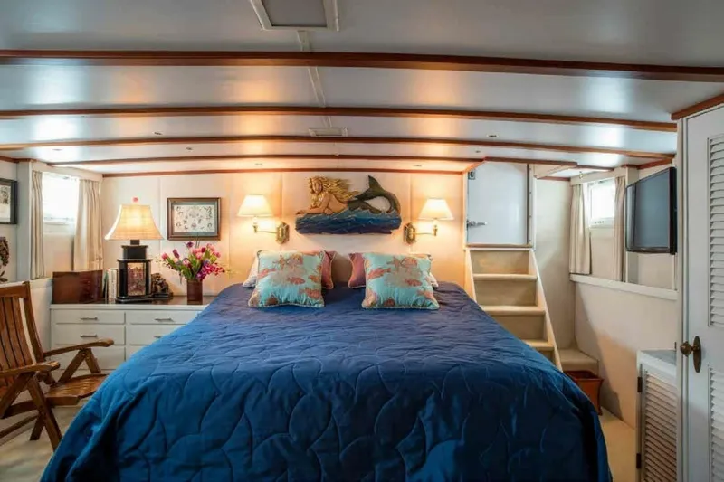 Seafari Yacht Photos Pics Luxurious 1975 Burger Raised Pilothouse CPMY yacht bedroom with nautical decor and cozy ambiance.