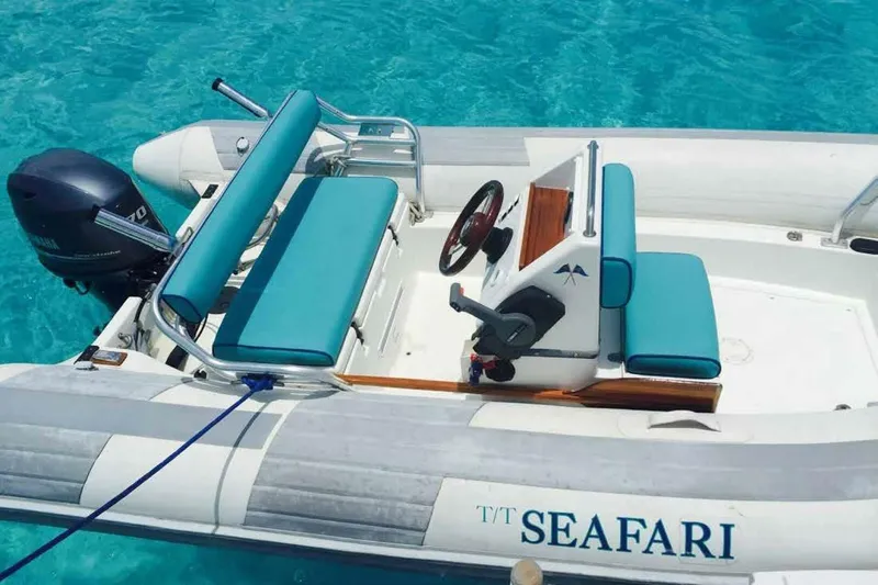 Seafari Yacht Photos Pics Inflatable boat "Seafari" with teal seats on clear blue water, 1975 Burger Raised Pilothouse CPMY.