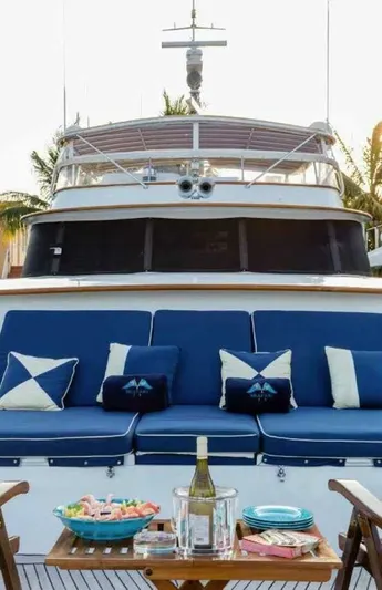 Seafari Yacht Photos Pics 1975 Burger Raised Pilothouse CPMY yacht with blue seating and outdoor dining setup.