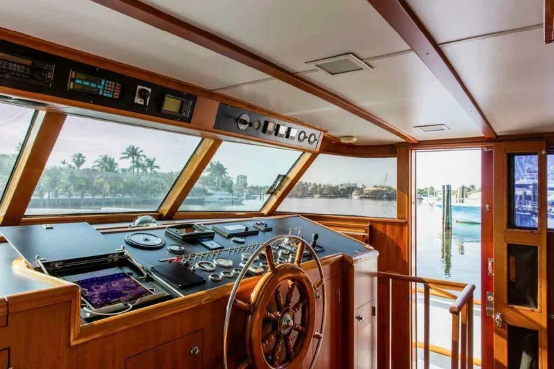 Seafari Yacht Photos Pics Pilothouse interior of 1975 Burger Raised Pilothouse CPMY yacht with wooden steering wheel.