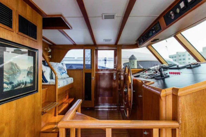 Seafari Yacht Photos Pics 1975 Burger Raised Pilothouse CPMY interior with wooden helm and nautical decor.