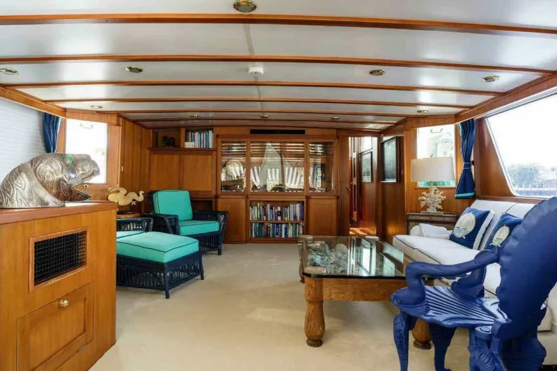 Seafari Yacht Photos Pics Luxurious 1975 Burger Raised Pilothouse CPMY yacht interior with elegant wood paneling and plush seating.