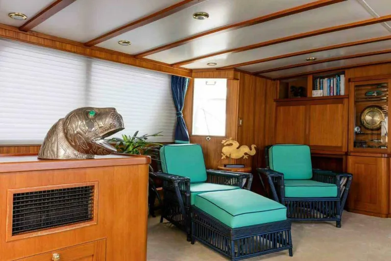 Seafari Yacht Photos Pics Interior of 1975 Burger Raised Pilothouse CPMY with teal seating and wooden decor.