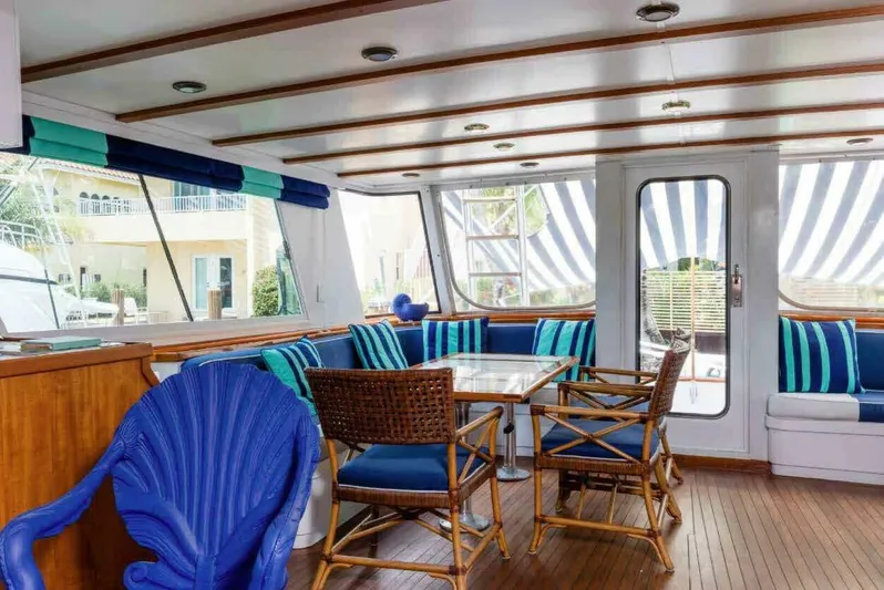 Seafari Yacht Photos Pics Interior of 1975 Burger Raised Pilothouse CPMY yacht with nautical-themed seating and decor.