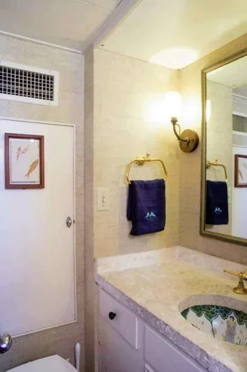 Seafari Yacht Photos Pics Bathroom interior of 1975 Burger Raised Pilothouse CPMY yacht with elegant decor.