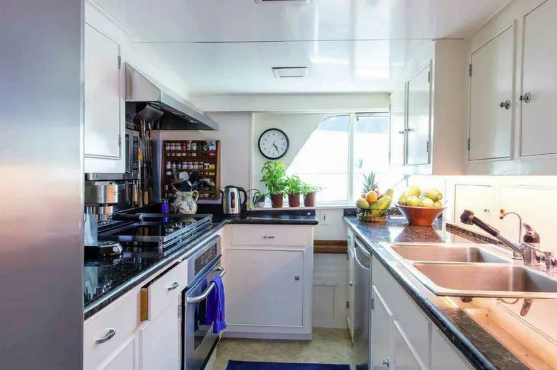 Seafari Yacht Photos Pics Kitchen interior of 1975 Burger Raised Pilothouse CPMY yacht with modern appliances and decor.