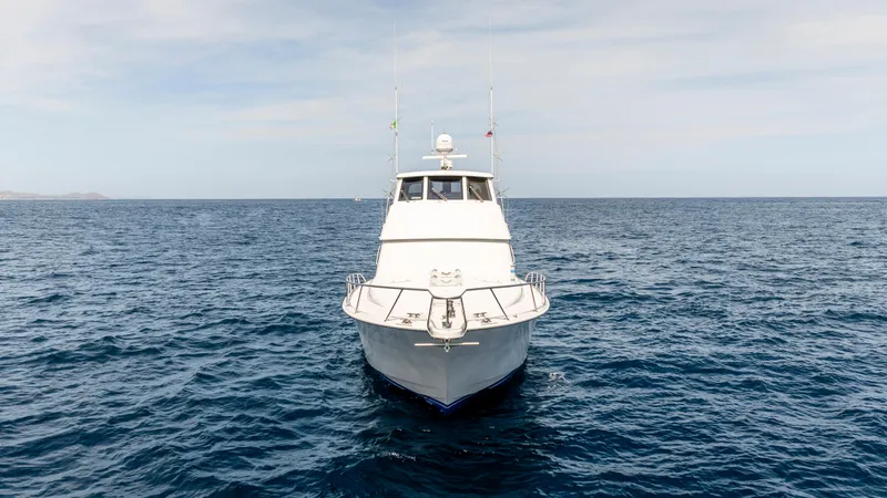 Strictly Business Yacht Photos Pics Front view of 2004 Hatteras 65 Enclosed Bridge yacht on open sea.