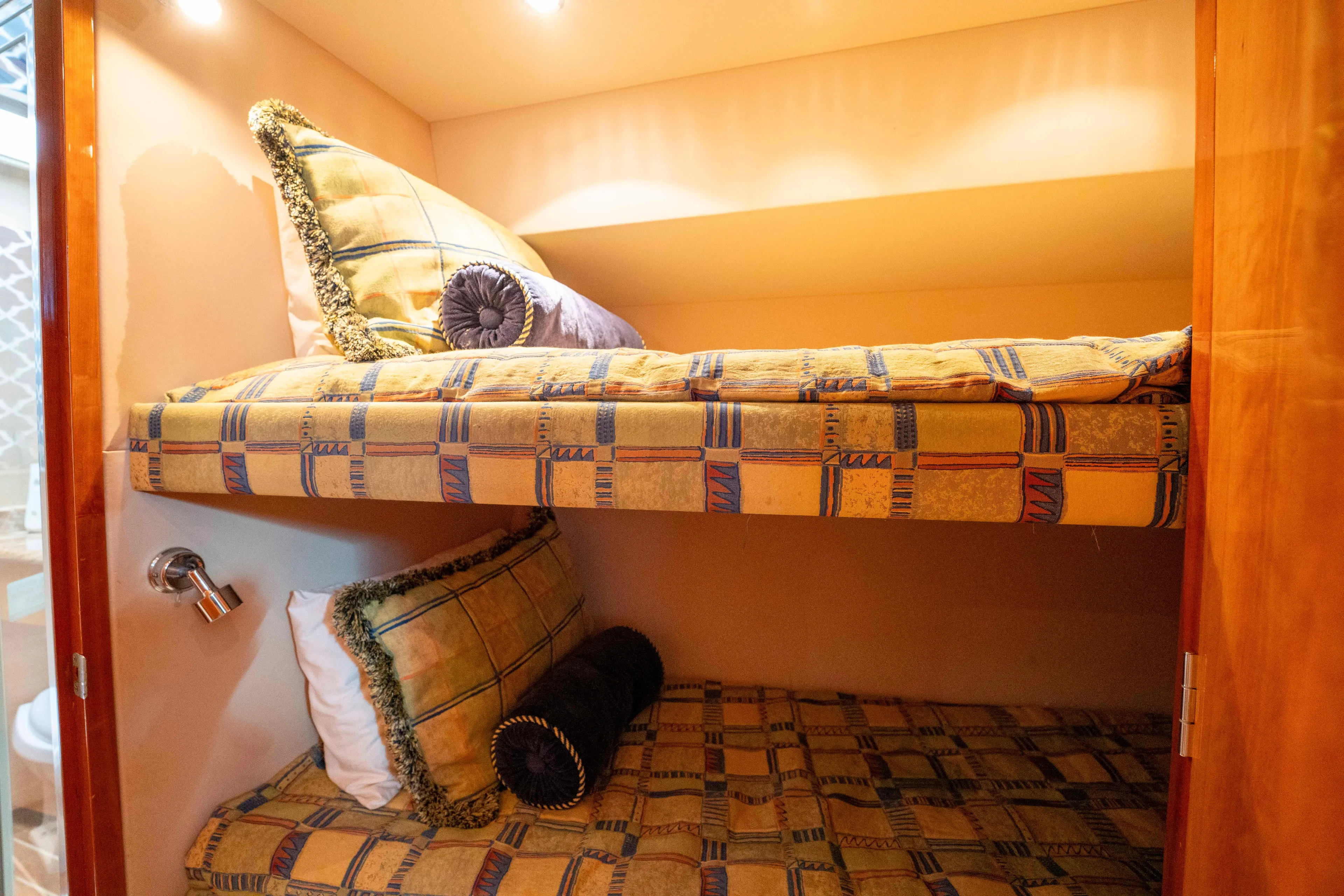 Strictly Business Yacht Photos Pics Bunk beds in 2004 Hatteras 65 Enclosed Bridge yacht cabin with patterned bedding.