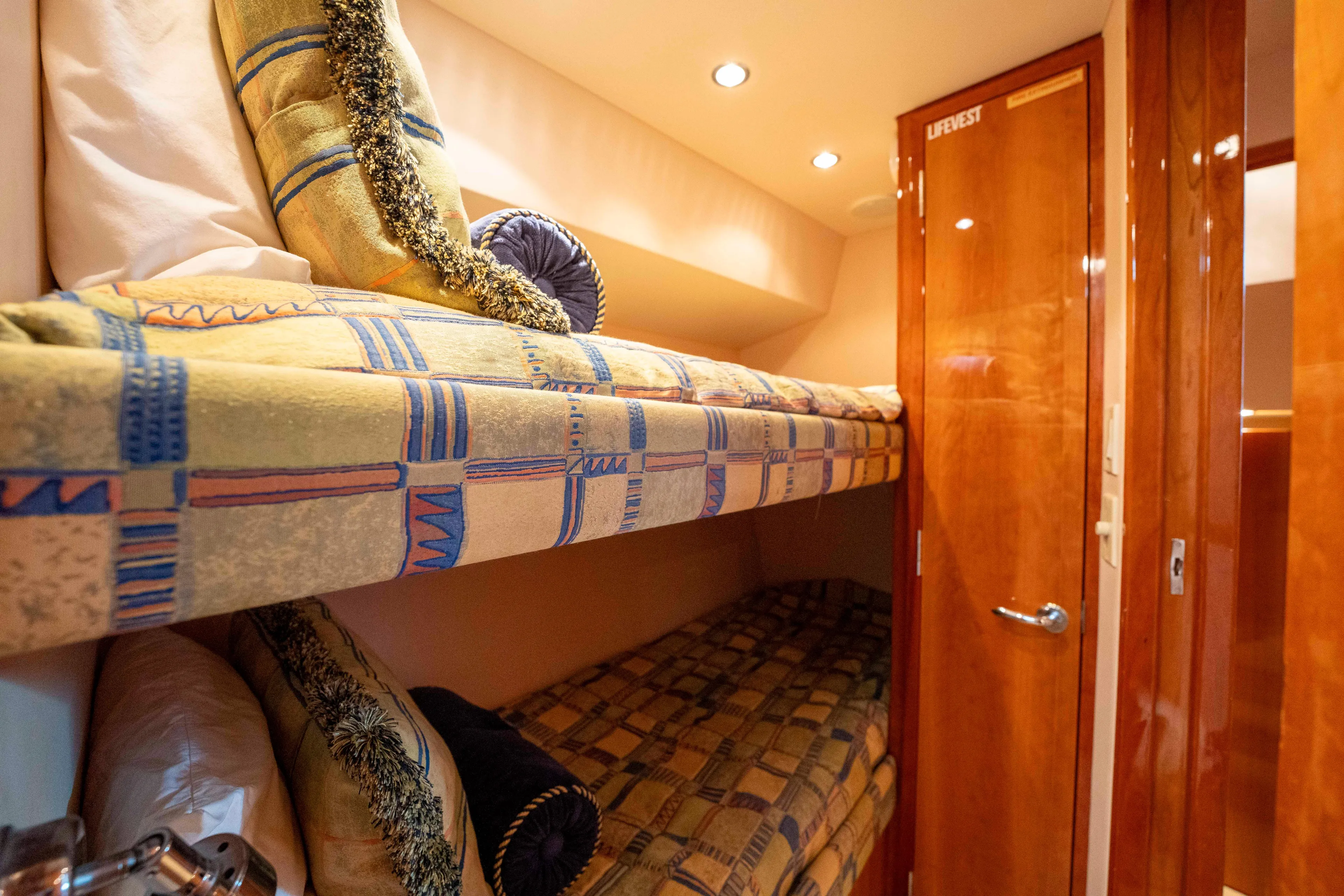 Strictly Business Yacht Photos Pics Bunk beds in 2004 Hatteras 65 Enclosed Bridge yacht cabin with wooden door.