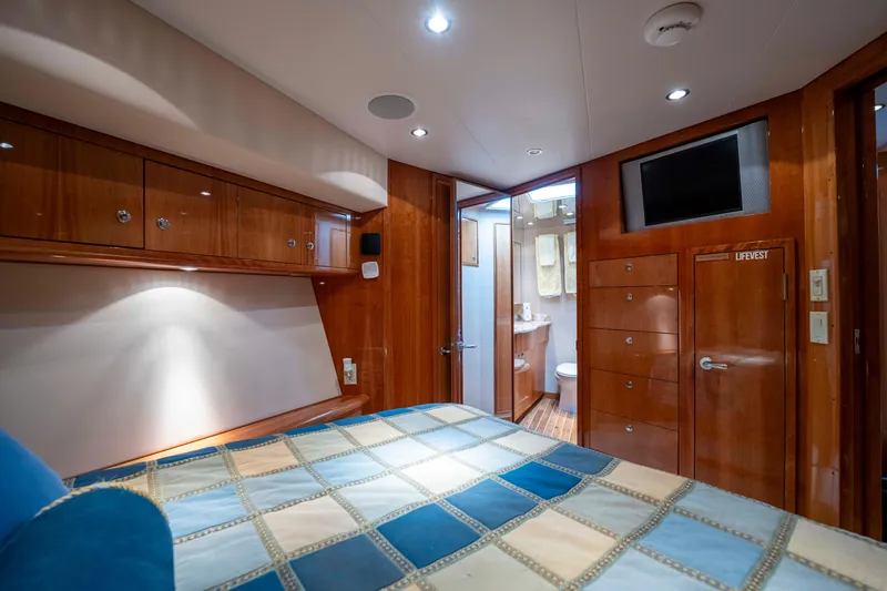 Strictly Business Yacht Photos Pics Luxurious cabin interior of 2004 Hatteras 65 Enclosed Bridge yacht with wood finishes.