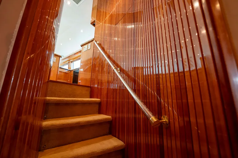 Strictly Business Yacht Photos Pics Staircase with wooden paneling inside 2004 Hatteras 65 Enclosed Bridge yacht.