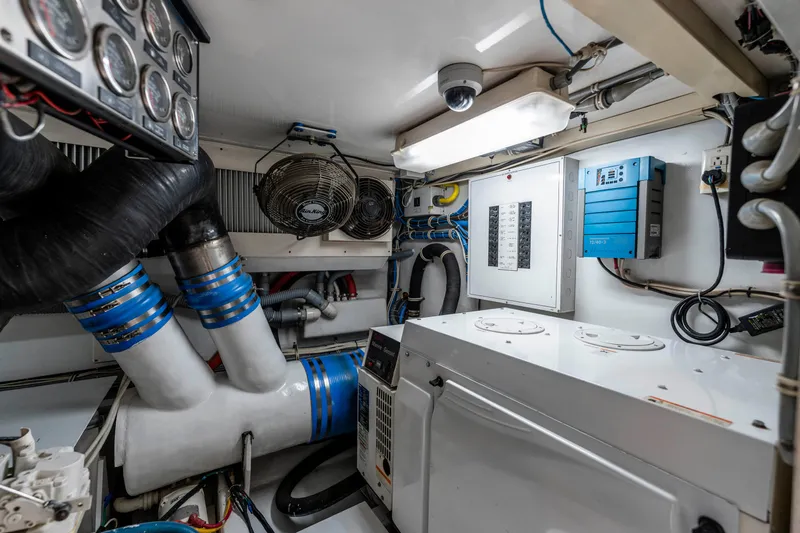Strictly Business Yacht Photos Pics Engine room of 2004 Hatteras 65 Enclosed Bridge yacht, featuring ventilation and control systems.