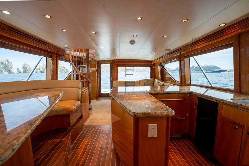 Strictly Business Yacht Photos Pics Luxurious interior of 2004 Hatteras 65 Enclosed Bridge yacht with ocean view.