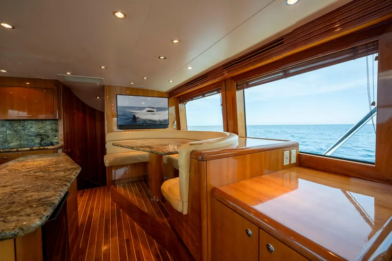 Strictly Business Yacht Photos Pics Luxurious interior of 2004 Hatteras 65 Enclosed Bridge yacht with ocean view.