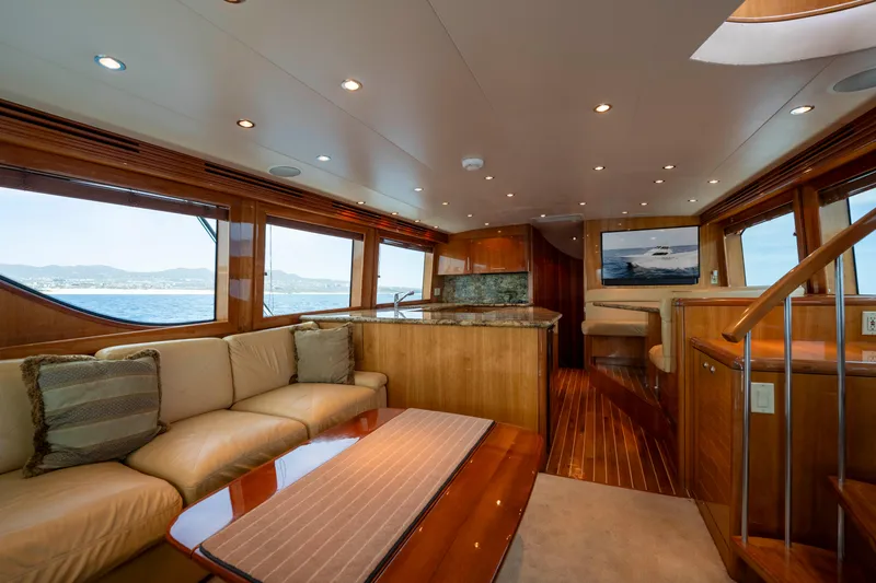 Strictly Business Yacht Photos Pics Luxurious interior of 2004 Hatteras 65 Enclosed Bridge yacht with elegant wood finishes.