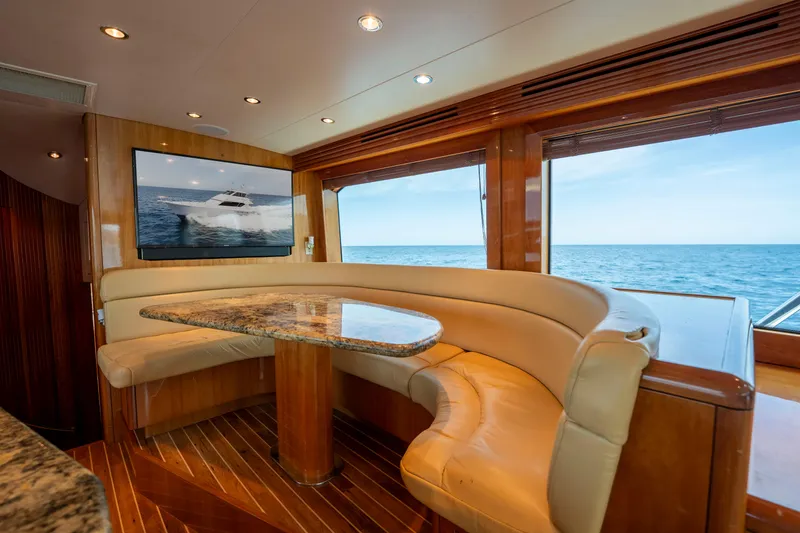 Strictly Business Yacht Photos Pics Luxurious interior of 2004 Hatteras 65 Enclosed Bridge yacht with ocean view.