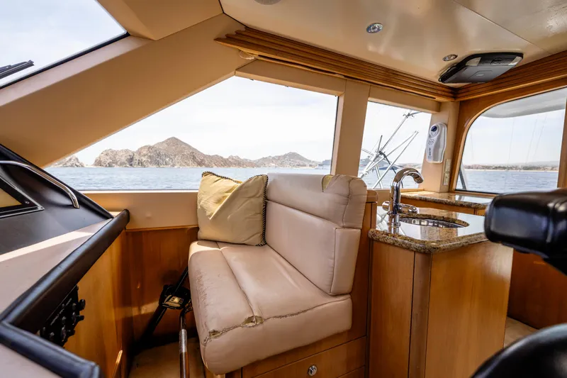 Strictly Business Yacht Photos Pics Interior of 2004 Hatteras 65 Enclosed Bridge yacht with ocean view.