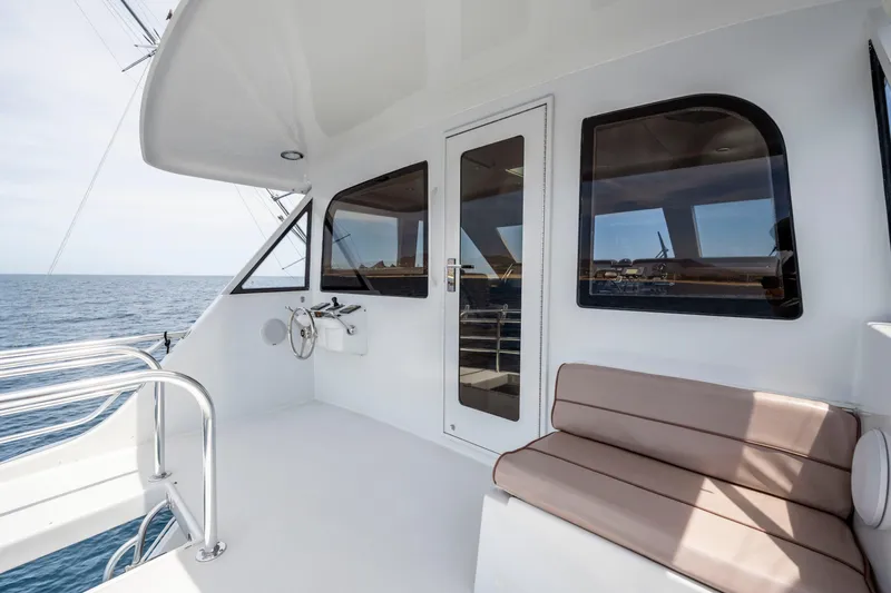 Strictly Business Yacht Photos Pics 2004 Hatteras 65 Enclosed Bridge yacht deck with seating and ocean view.