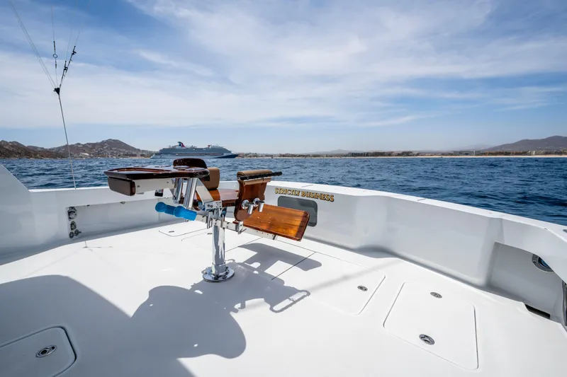 Strictly Business Yacht Photos Pics 2004 Hatteras 65 Enclosed Bridge yacht deck with ocean view and fishing chair.