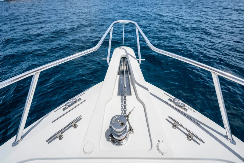 Strictly Business Yacht Photos Pics Bow view of 2004 Hatteras 65 Enclosed Bridge yacht on open water.