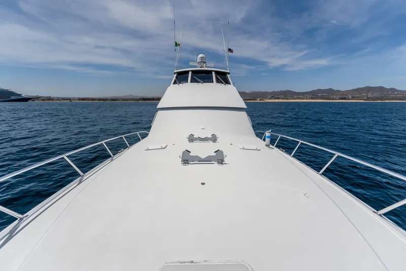 Strictly Business Yacht Photos Pics 2004 Hatteras 65 Enclosed Bridge yacht on open water, clear sky background.