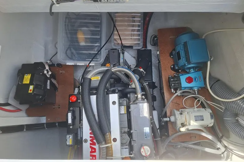 Yoff Yacht Photos Pics Engine compartment of a 2023 Lagoon 46 yacht, featuring Yanmar engine and various mechanical components.