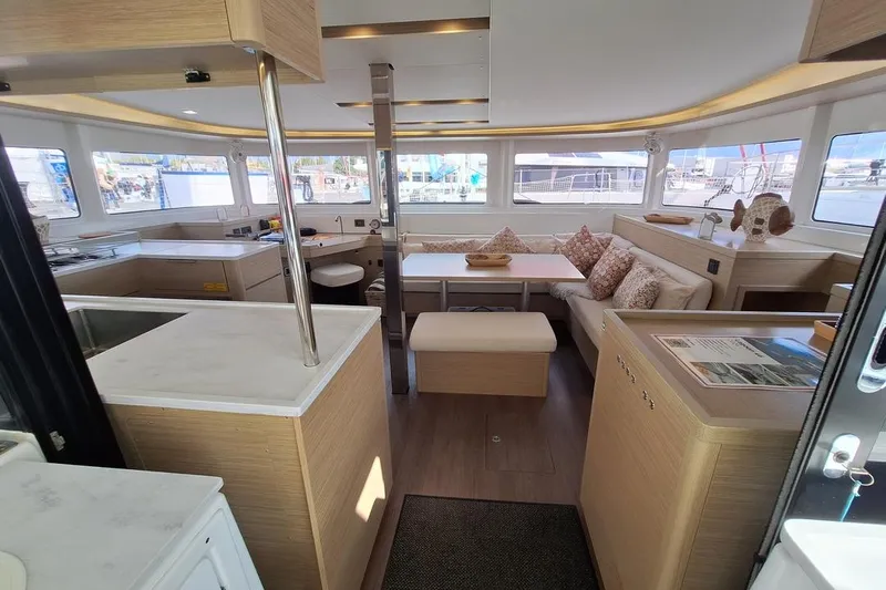 Yoff Yacht Photos Pics 2023 Lagoon 46 yacht interior with modern kitchen and cozy seating area.