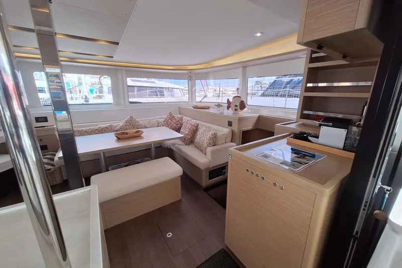 Yoff Yacht Photos Pics Luxurious interior of 2023 Lagoon 46 yacht with modern seating and elegant decor.