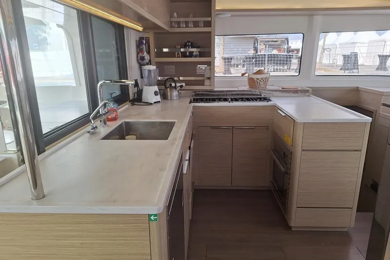 Yoff Yacht Photos Pics Modern kitchen interior of 2023 Lagoon 46 yacht with sleek countertops and appliances.