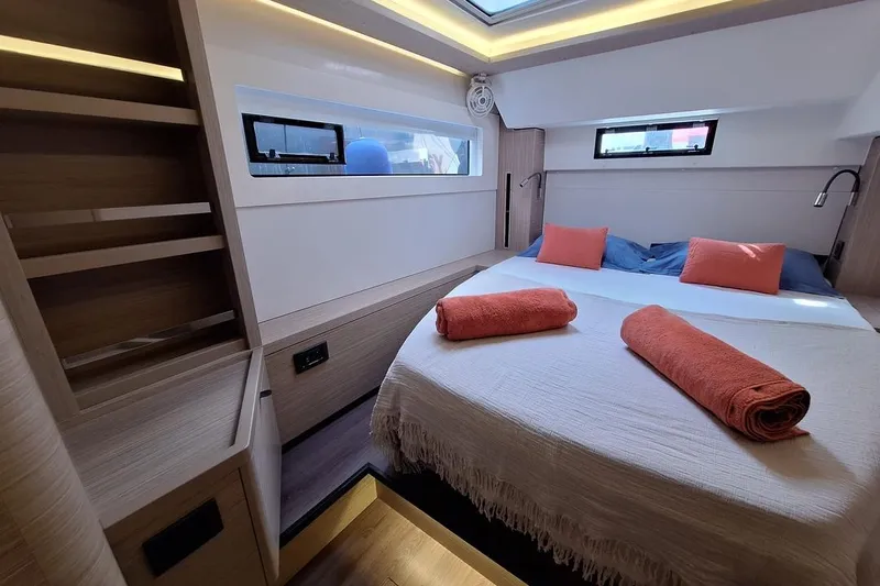 Yoff Yacht Photos Pics Luxurious cabin interior of 2023 Lagoon 46 yacht with cozy bed and modern design.
