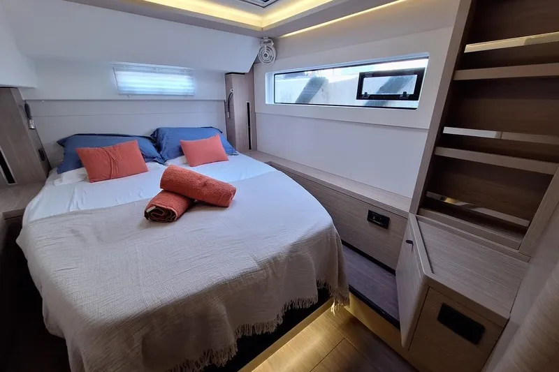 Yoff Yacht Photos Pics Luxurious cabin interior of 2023 Lagoon 46 catamaran with cozy bedding and modern design.
