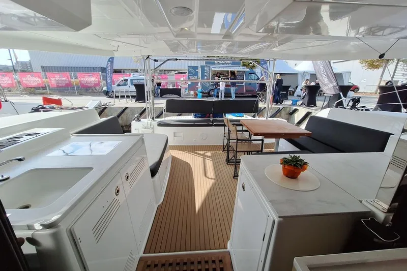 Yoff Yacht Photos Pics Spacious deck of 2023 Lagoon 46 catamaran with seating and dining area.