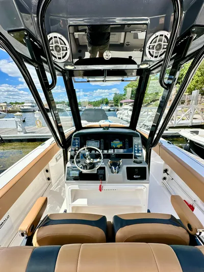  Yacht Photos Pics 2024 Robalo R250 Center Console boat interior with modern dashboard and steering wheel.