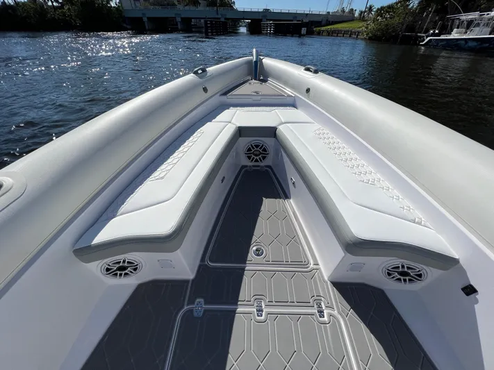  Yacht Photos Pics 2024 Airship 340 boat interior with cushioned seating and speakers on a sunny day.