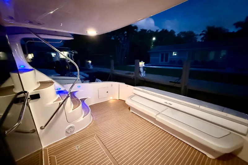  Yacht Photos Pics 1999 Sea Ray 560 Sedan Bridge yacht deck with elegant lighting and seating at dusk.