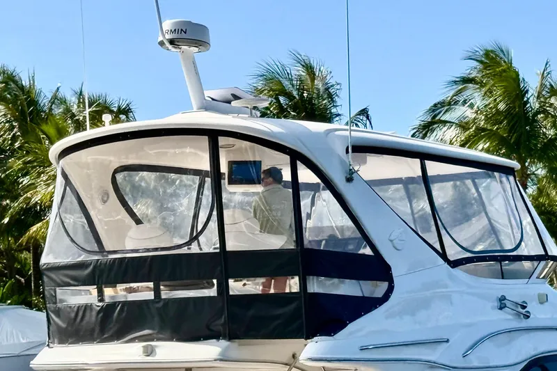  Yacht Photos Pics 1999 Sea Ray 560 Sedan Bridge yacht with enclosed cockpit, surrounded by palm trees.