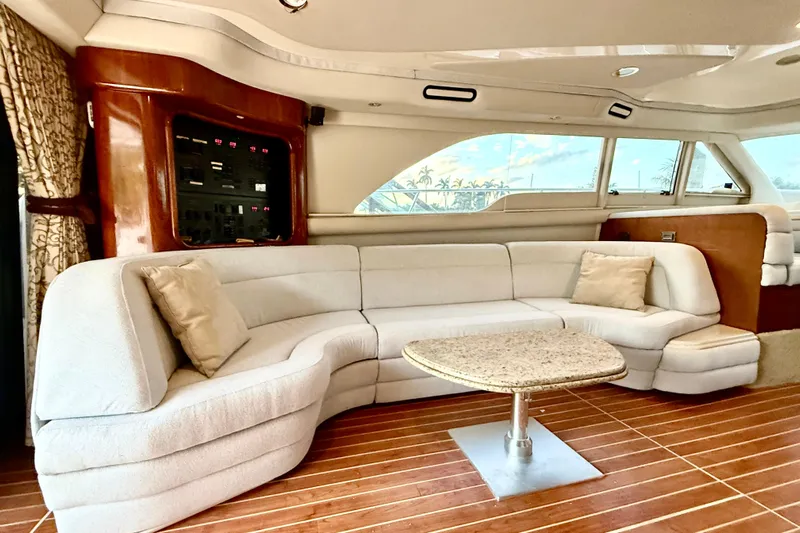  Yacht Photos Pics Luxurious interior of a 1999 Sea Ray 560 Sedan Bridge yacht with plush seating and elegant decor.