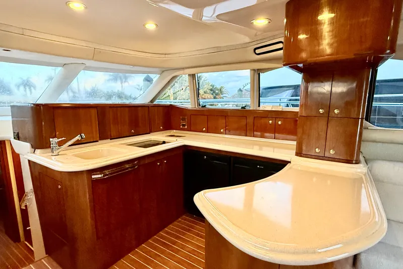  Yacht Photos Pics Luxurious 1999 Sea Ray 560 Sedan Bridge yacht kitchen with elegant wood cabinetry and modern fixtures.