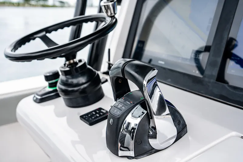  Yacht Photos Pics 2022 Jupiter 32 boat helm with steering wheel and control panel.