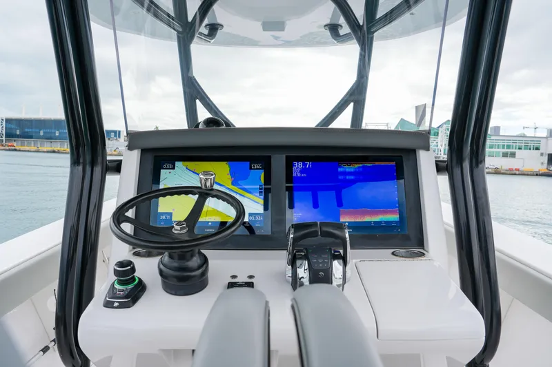  Yacht Photos Pics 2022 Jupiter 32 boat helm with navigation screens and steering wheel.