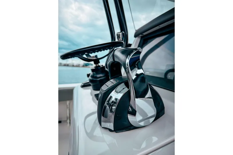  Yacht Photos Pics Close-up of 2022 Jupiter 32 boat controls with steering wheel and throttle.