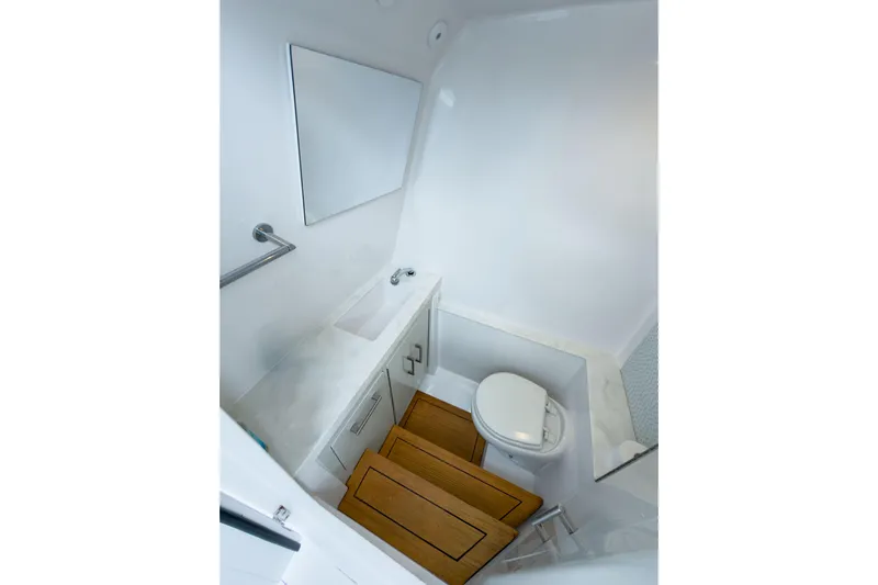  Yacht Photos Pics 2022 Jupiter 32 boat interior bathroom with wooden steps, sink, and toilet.