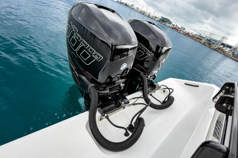  Yacht Photos Pics Twin outboard engines on a 2022 Jupiter 32 boat, docked in a marina.
