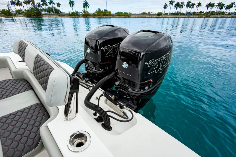  Yacht Photos Pics 2022 Jupiter 32 boat with dual Racing 400 outboard engines on a calm water backdrop.