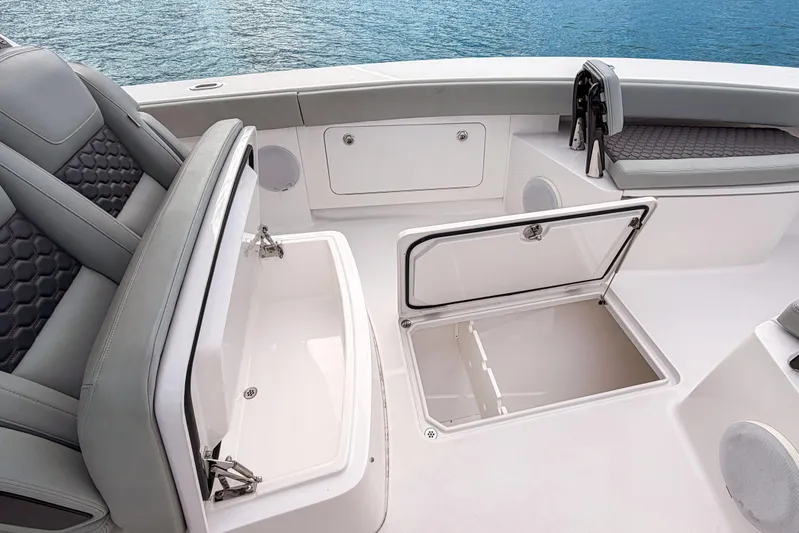  Yacht Photos Pics 2022 Jupiter 32 boat interior with open storage compartments and cushioned seating.