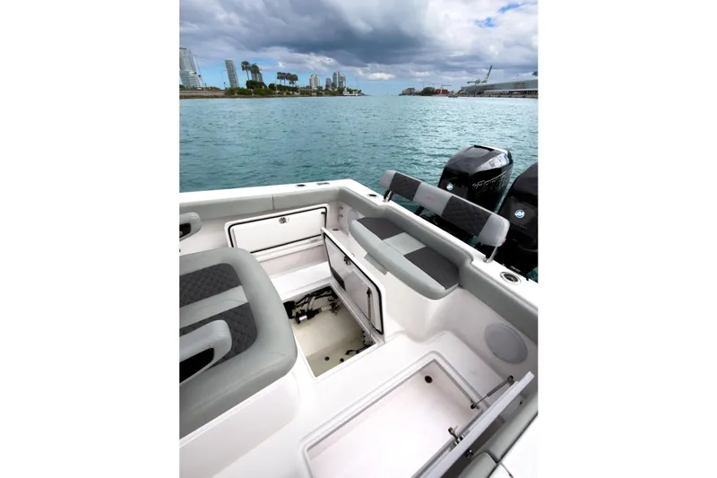  Yacht Photos Pics 2022 Jupiter 32 boat interior with open storage, dual engines, and waterfront cityscape.