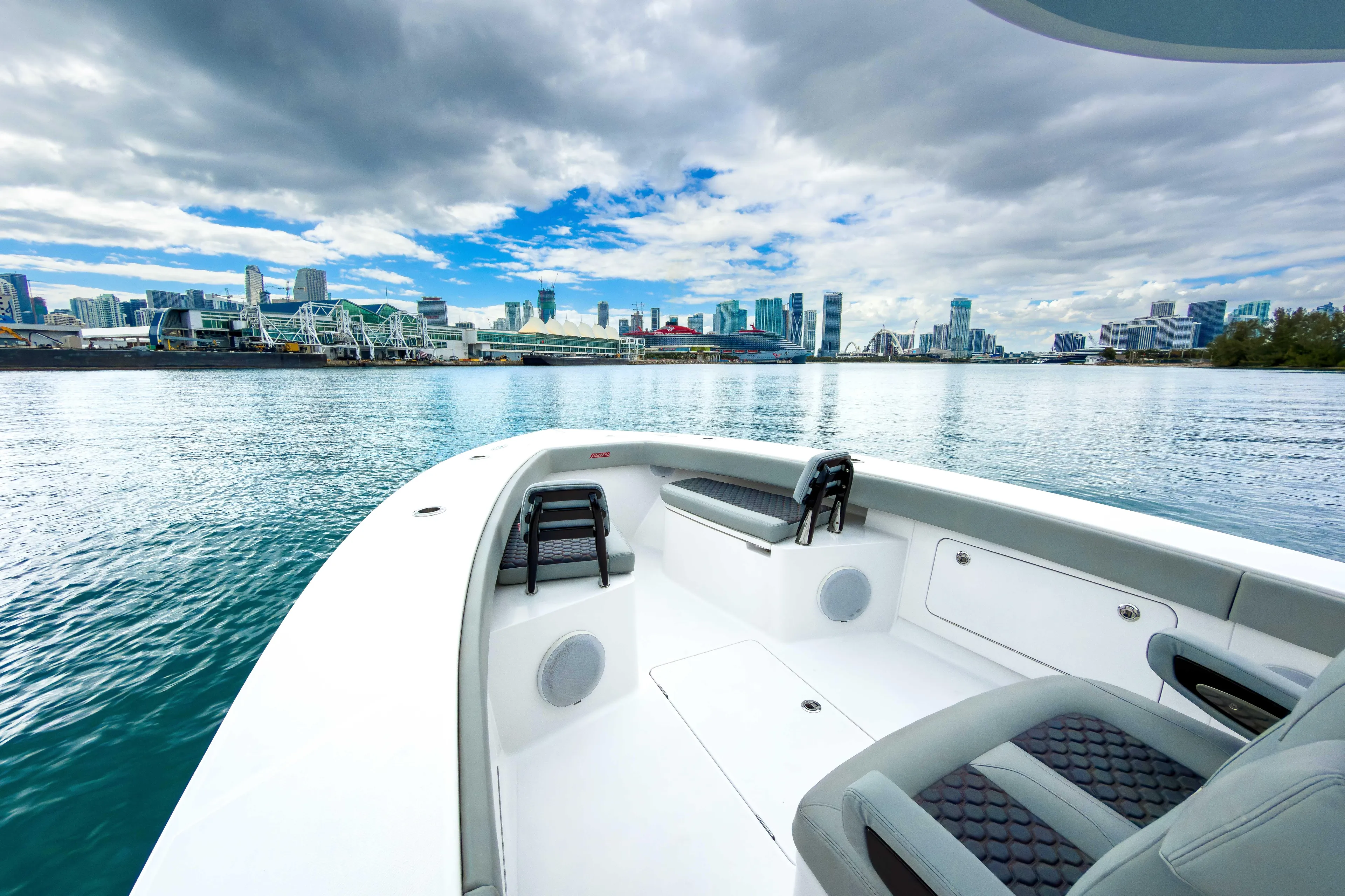  Yacht Photos Pics 2022 Jupiter 32 boat on water with city skyline in background.