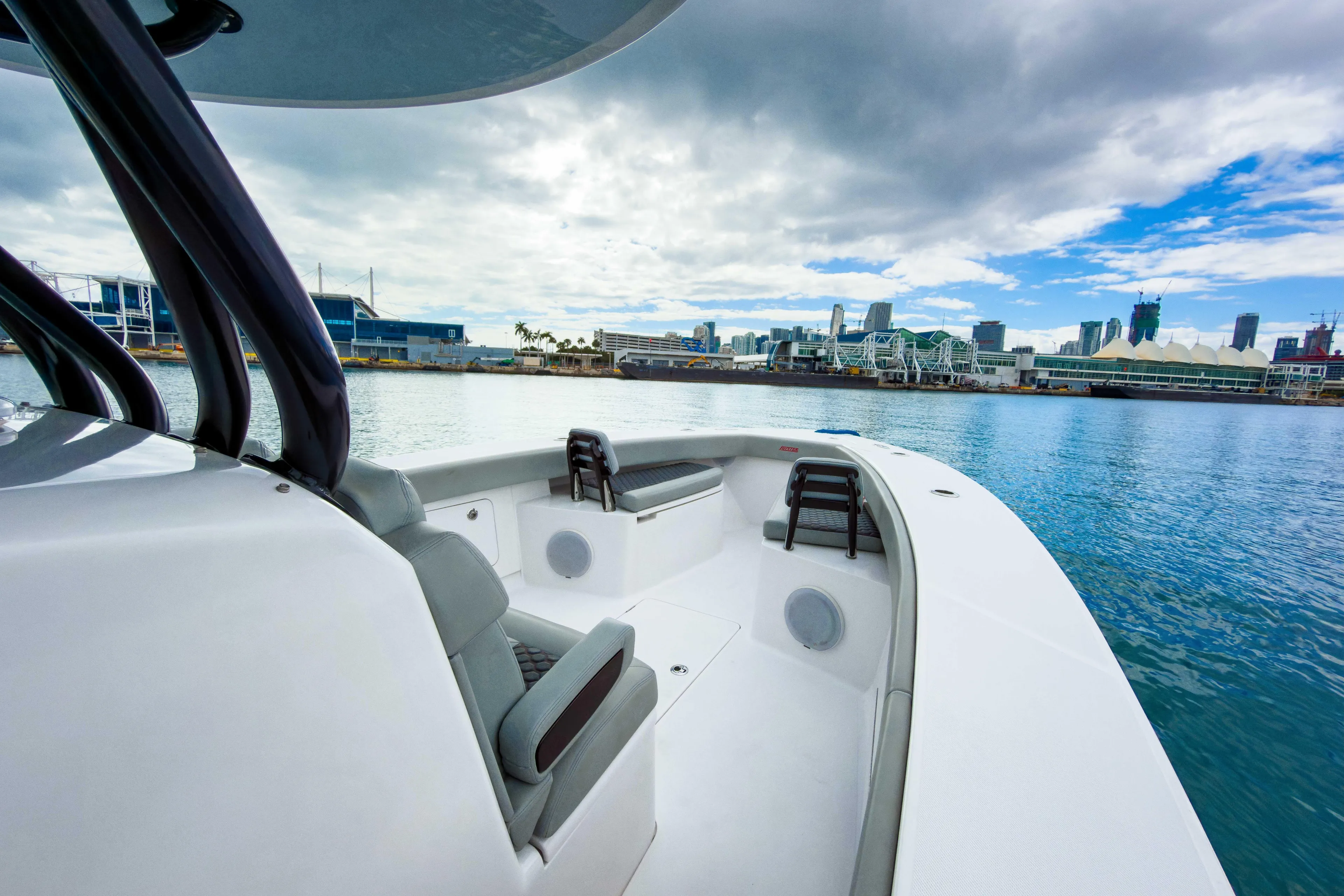  Yacht Photos Pics 2022 Jupiter 32 boat on water with city skyline in background.