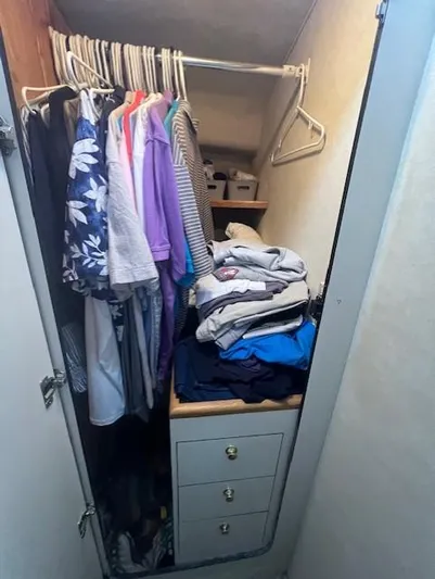  Yacht Photos Pics Closet inside 1997 Sea Ray 400 Sundancer with hanging clothes and folded garments.