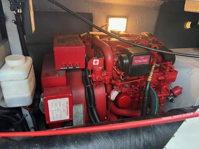  Yacht Photos Pics Engine compartment of a 1997 Sea Ray 400 Sundancer, featuring a red marine engine.
